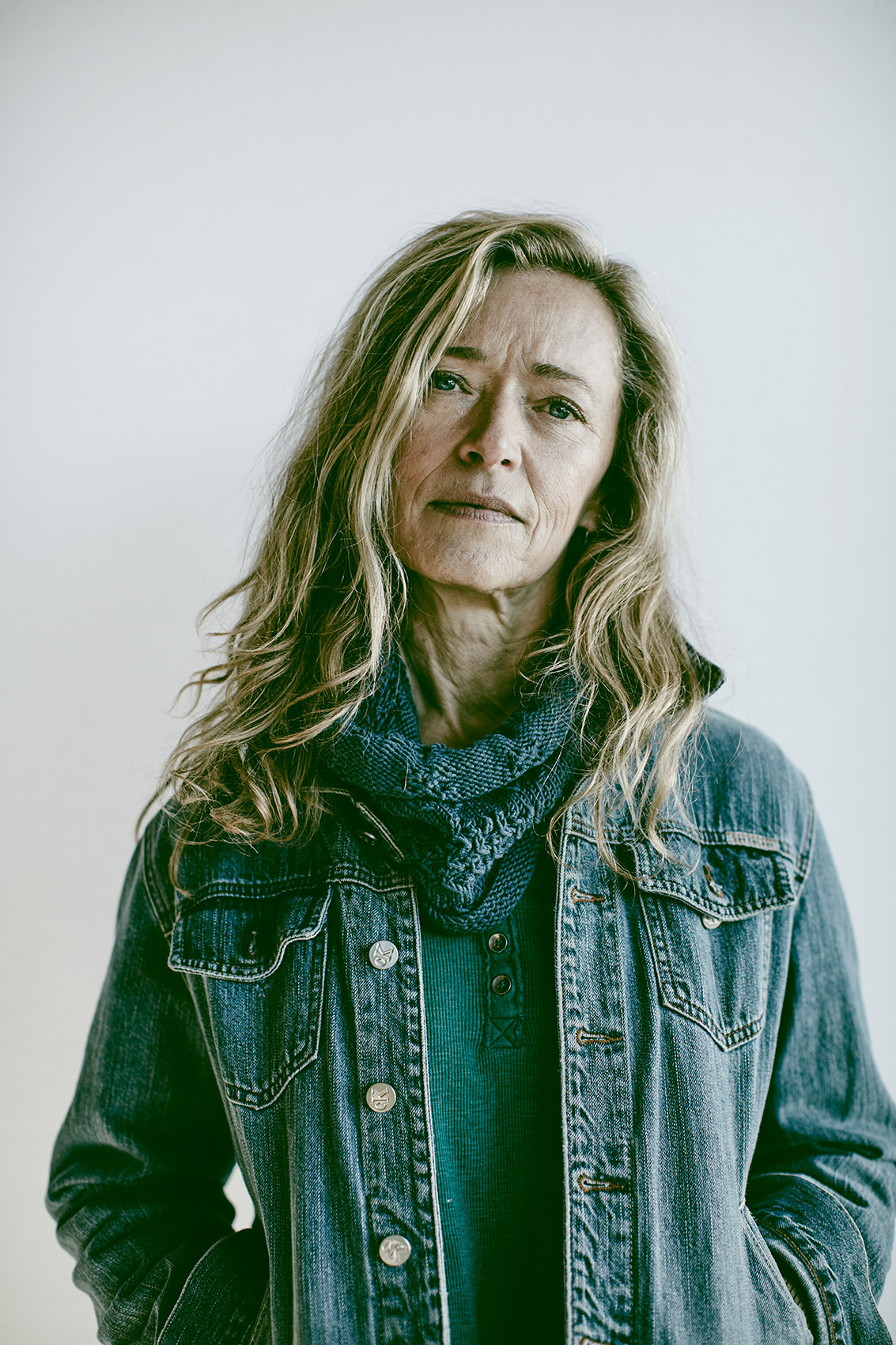 woman with blonde hair wearing a denim jacket