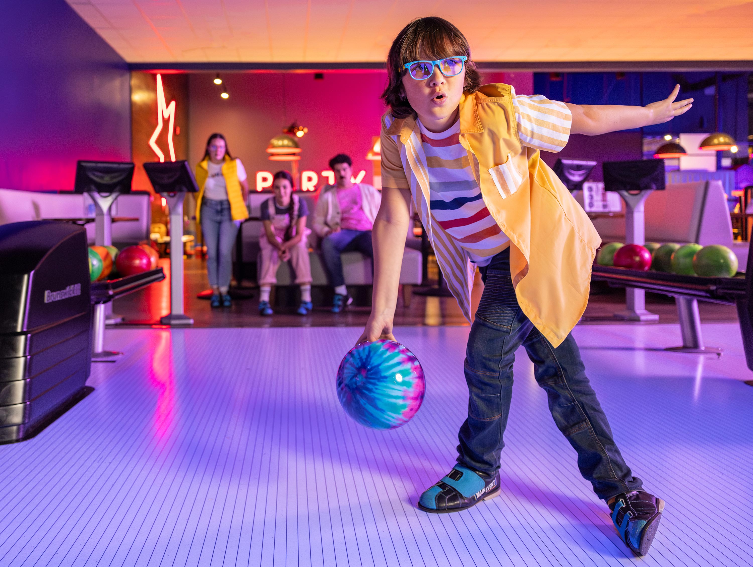 Young boy at a bowling alley about to bowl