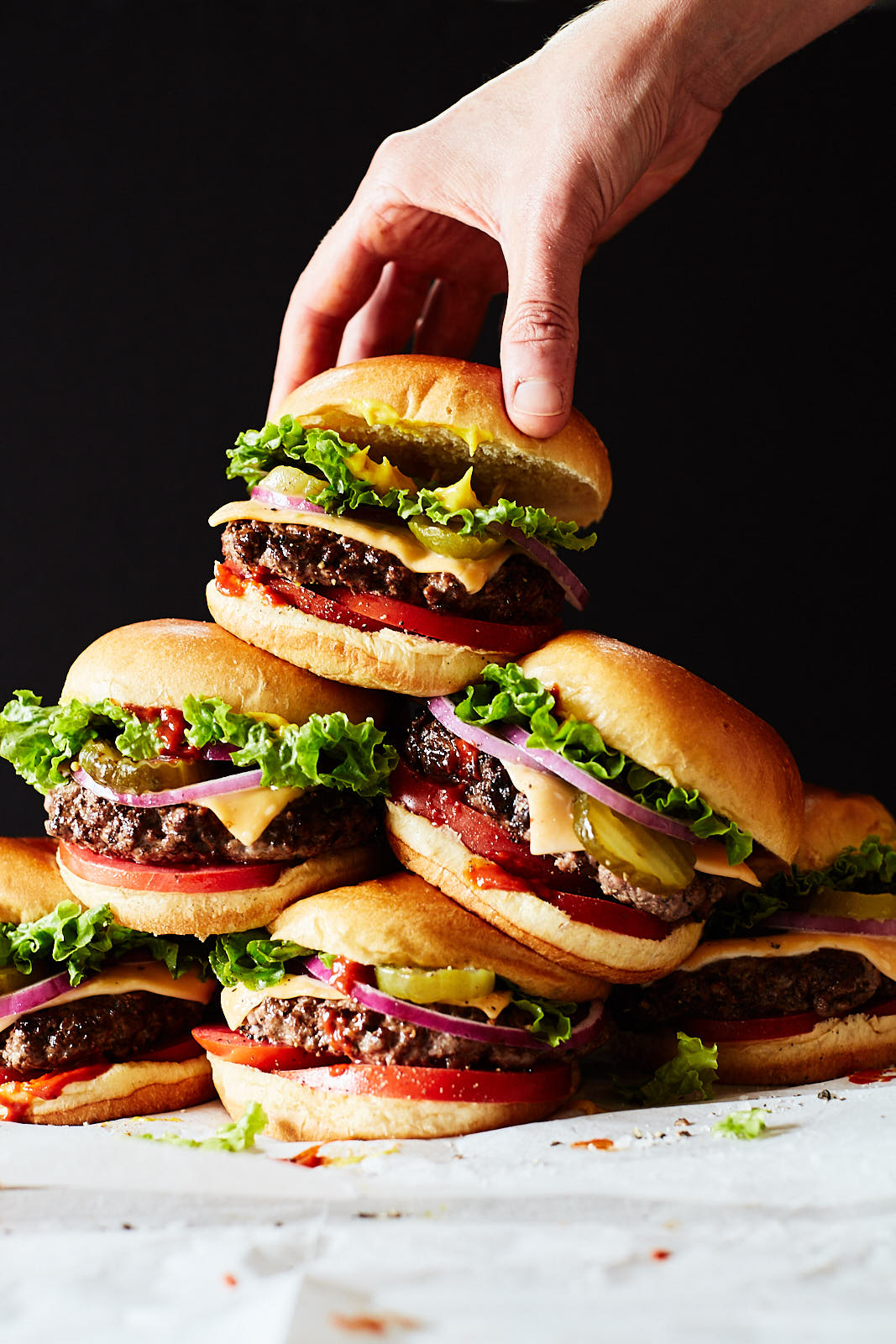 Hand lifting cheeseburger