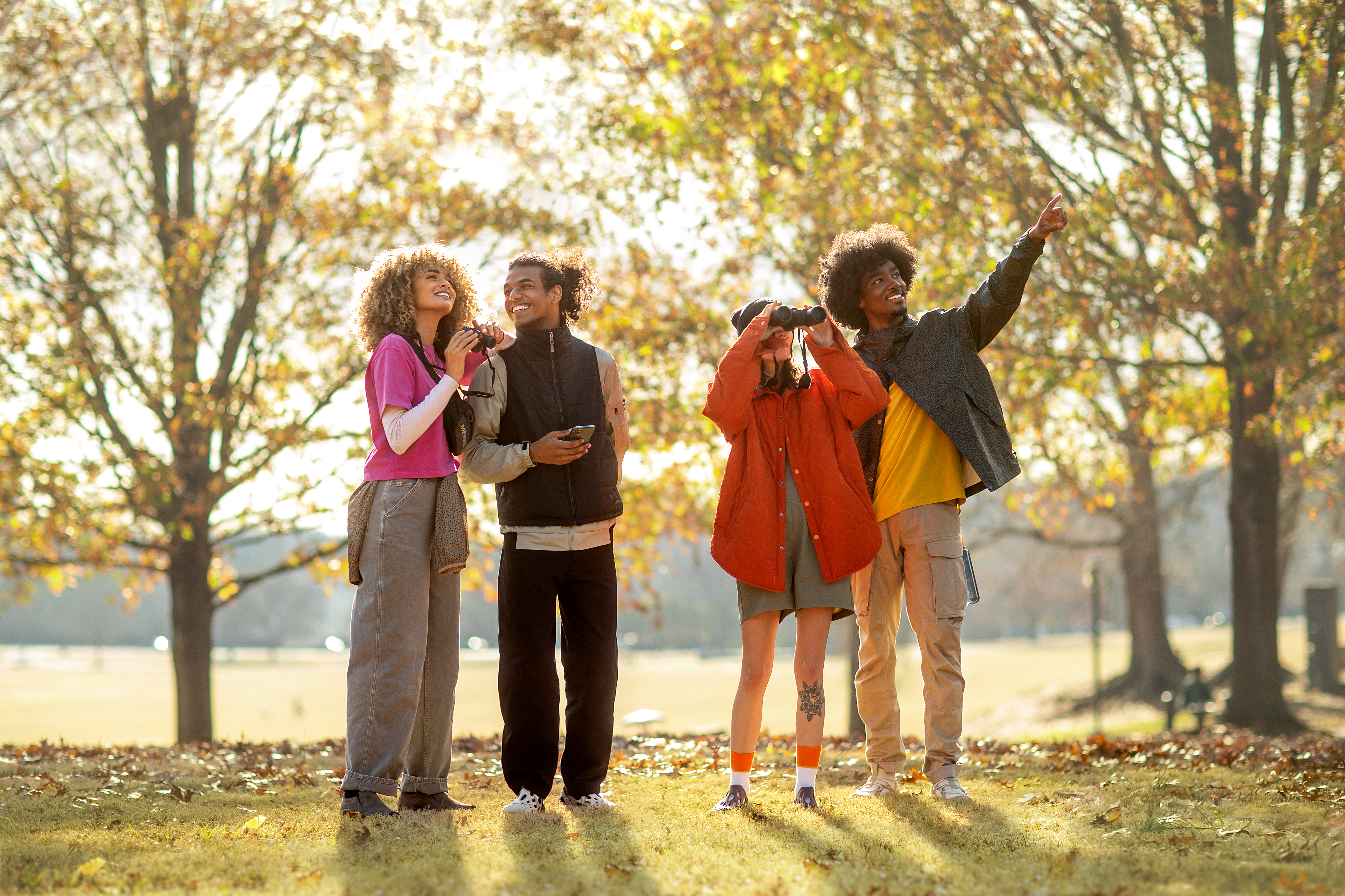 Group of teenagers birdwatching in Piedmont Park, Atlanta.