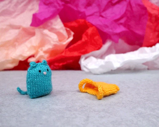 Naughty blue cat jumping into yellow bag. 