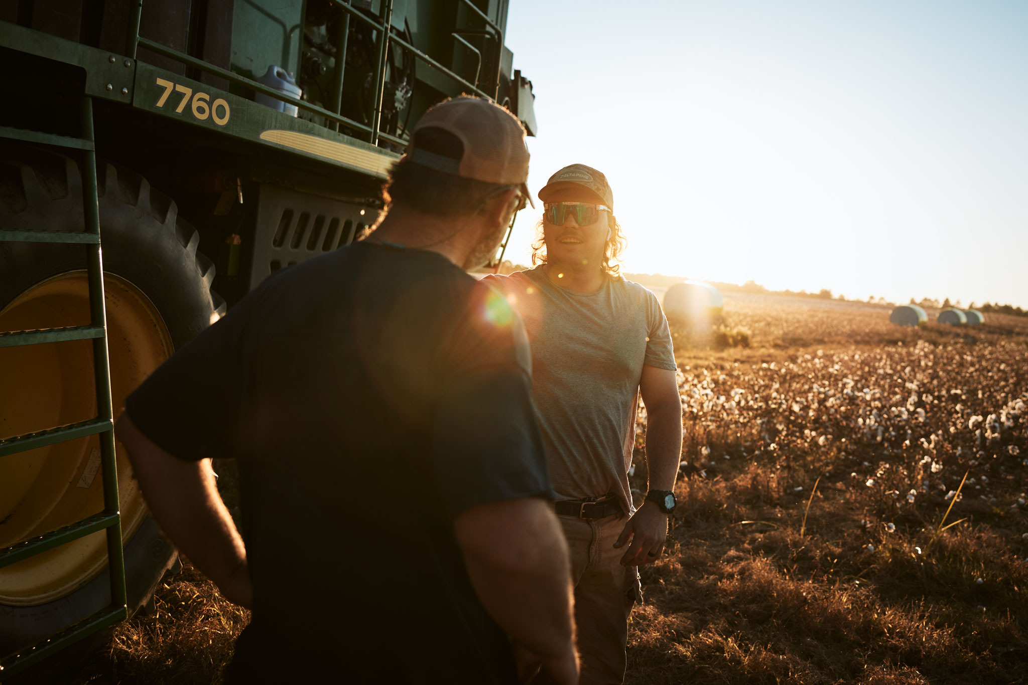 Farmers in Cotton Field by Harvester