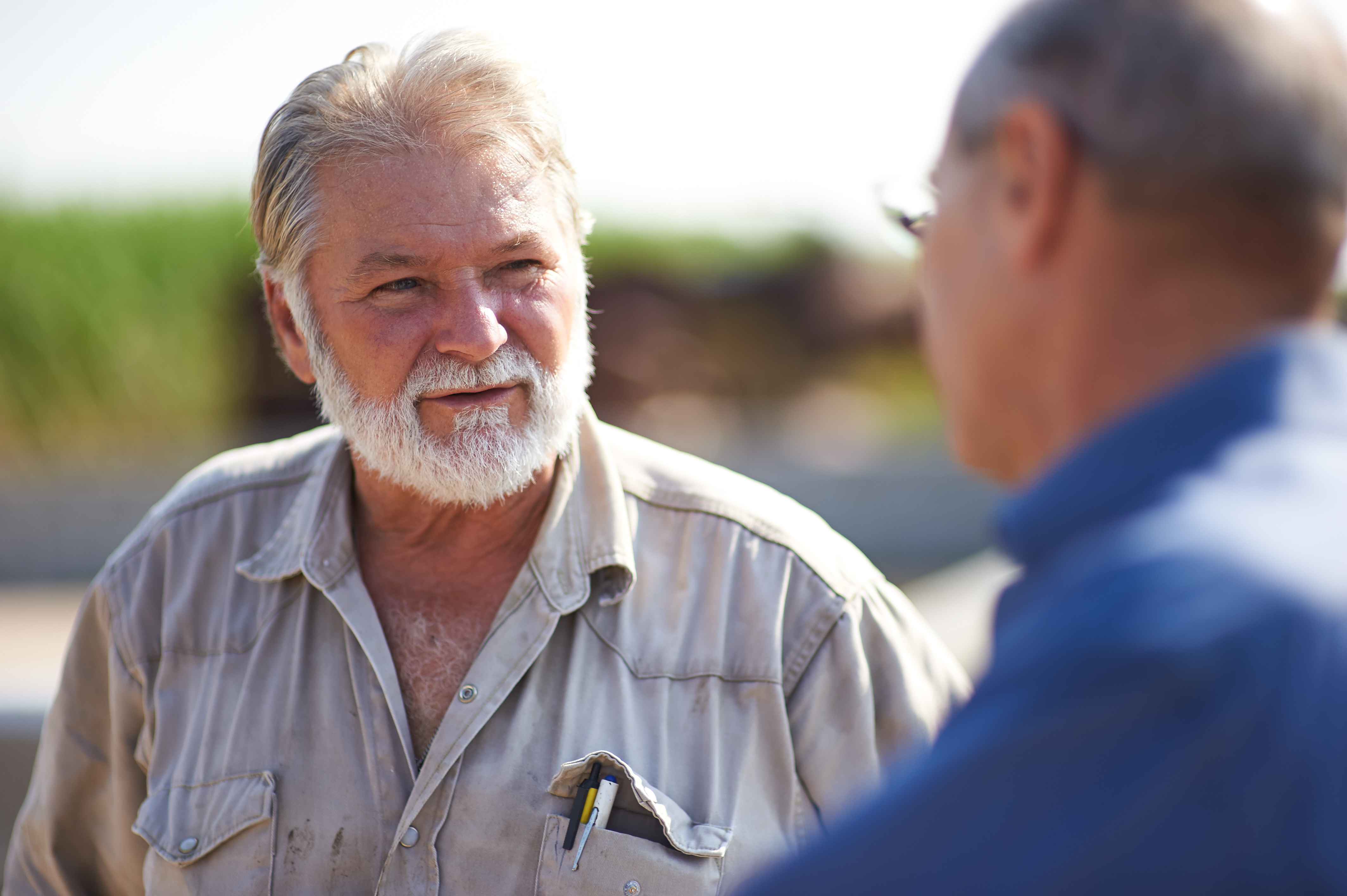 A lifetime of hard work and wisdom shared in a meaningful conversation. The lines of experience and the power of connection show the strength that comes from years of dedication.