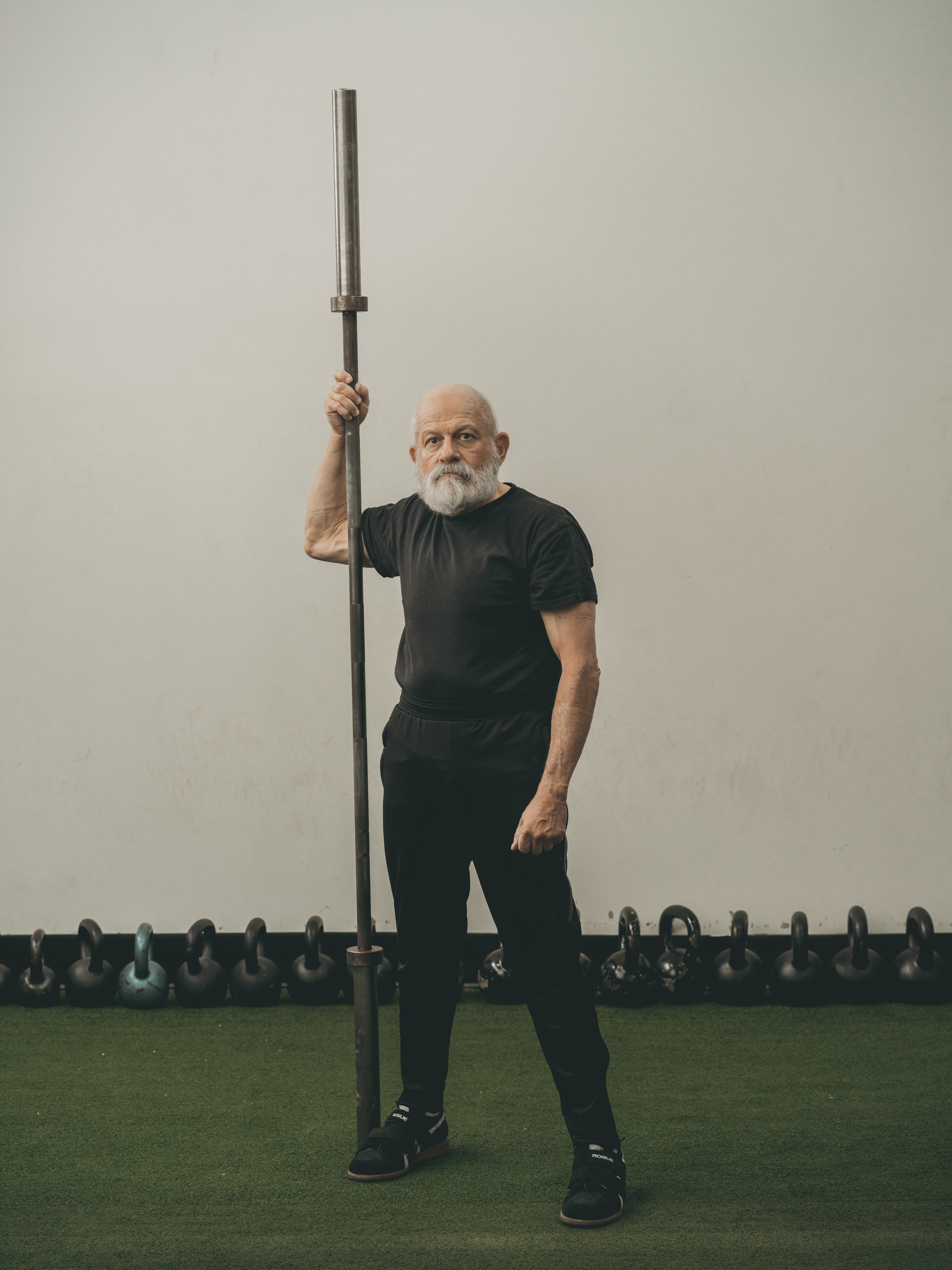 Senior man in gym with equipment 