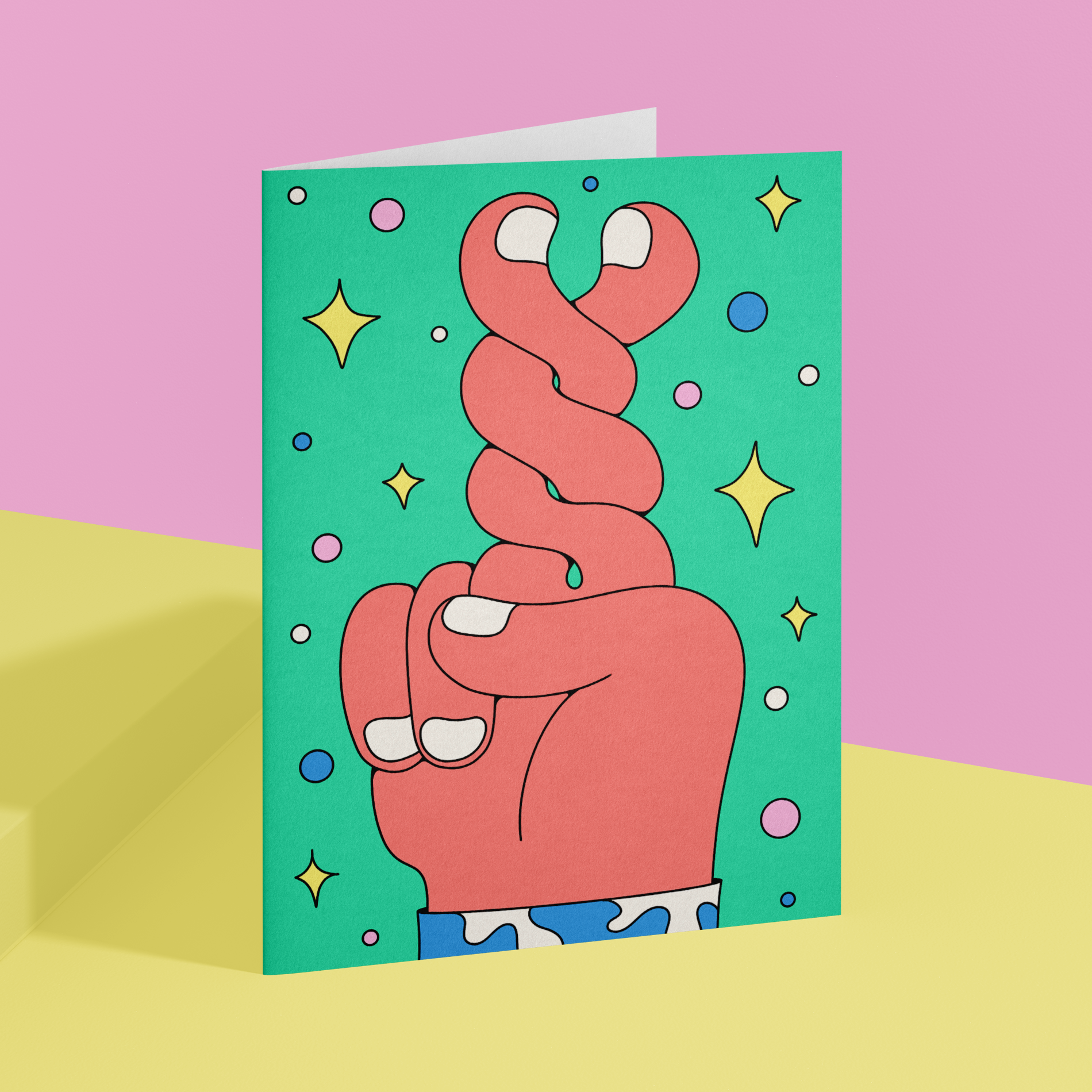 A playful illustrated greeting card showing crossed fingers against a mint background with colorful dots and sparkling stars.