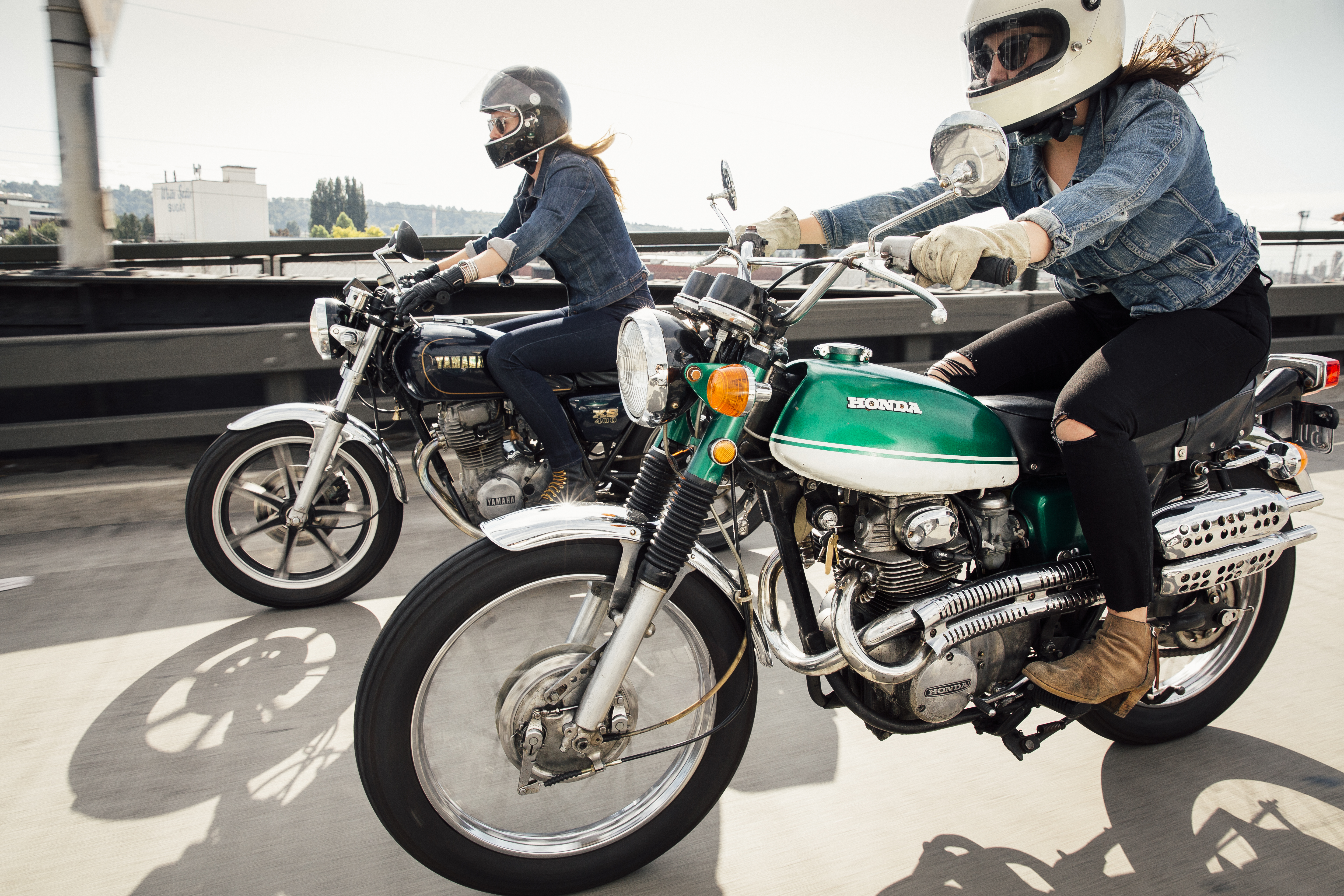 Two women riding motorcycles